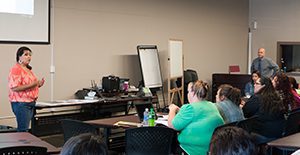 Micaela Razo presents to a group of parents and family members.