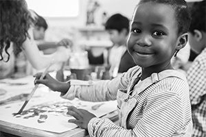 A child paints in class - LEV Join Us