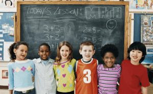 Children standing in front of a chalkboard - League of Education Voters