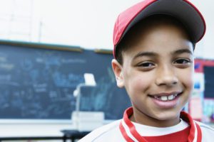 Portrait of a boy smiling in a classroom --- Image by © Andersen Ross/Blend Images/Corbis