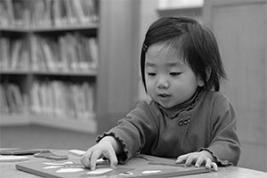 A toddler plays with a puzzle.