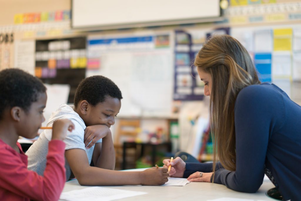 Teacher working with 2 students